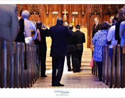 guest standing in the aisle to just take photographs during wedding service